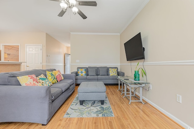 living room featuring hardwood / wood-style flooring, crown molding, and ceiling fan