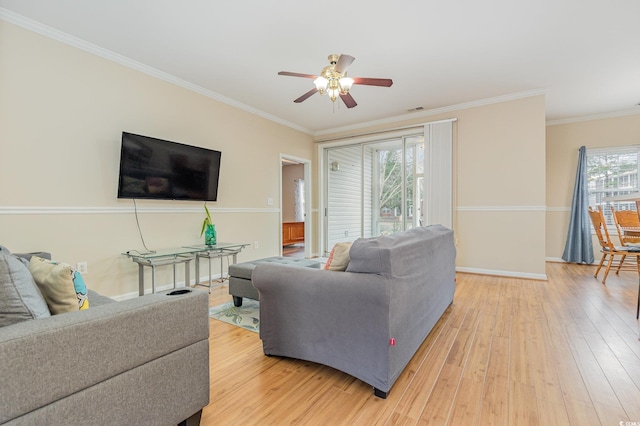 living room with hardwood / wood-style floors, crown molding, and ceiling fan