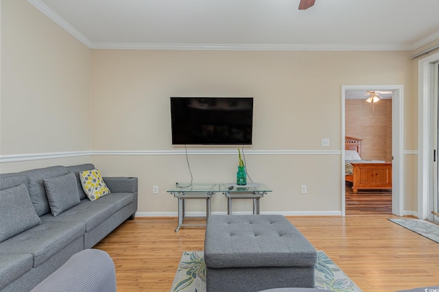 living room featuring ornamental molding, hardwood / wood-style floors, and ceiling fan