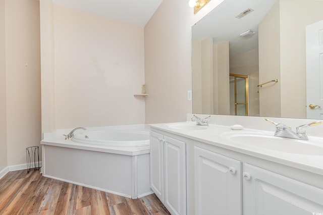 bathroom with vanity, hardwood / wood-style flooring, and shower with separate bathtub