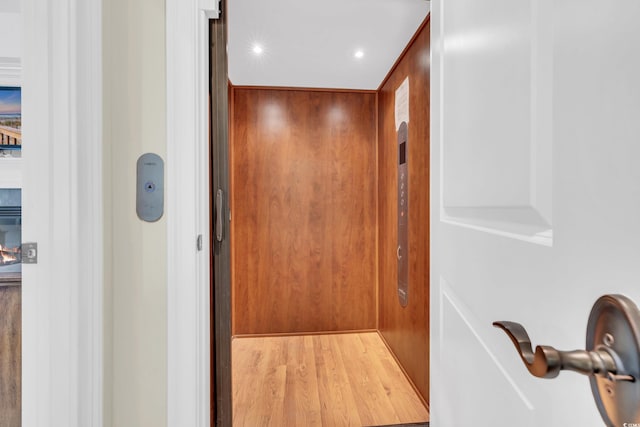 interior details featuring hardwood / wood-style floors and elevator