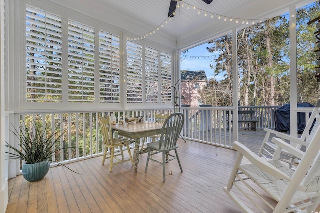 wooden terrace featuring grilling area and ceiling fan