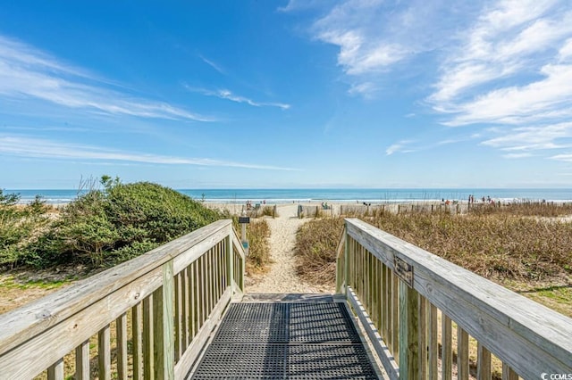 view of home's community featuring a water view and a view of the beach