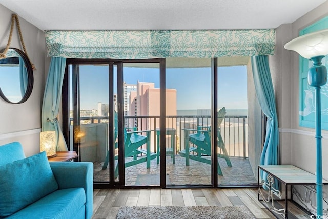 doorway to outside with hardwood / wood-style floors and a textured ceiling