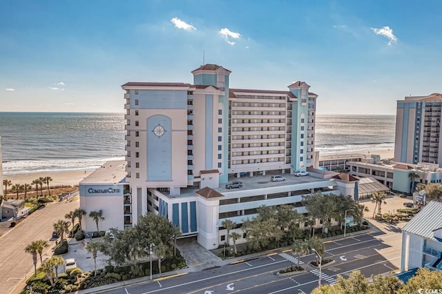 drone / aerial view featuring a water view and a beach view