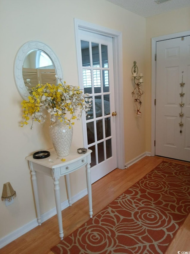 doorway with hardwood / wood-style floors