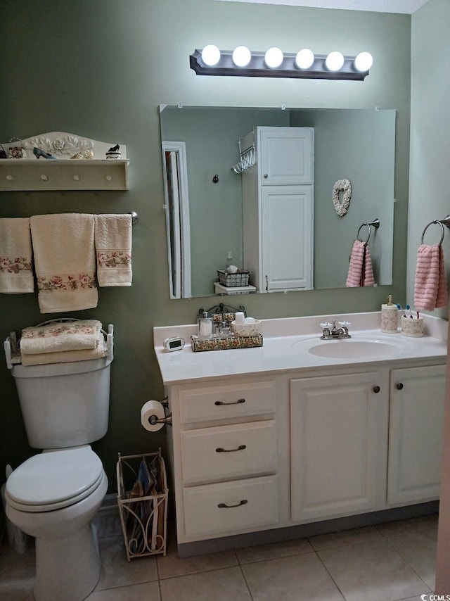 bathroom featuring tile patterned floors, vanity, and toilet