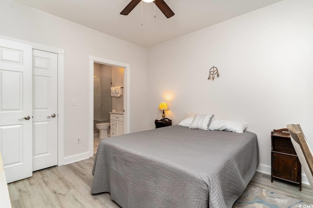 bedroom with ensuite bath, light hardwood / wood-style floors, and ceiling fan