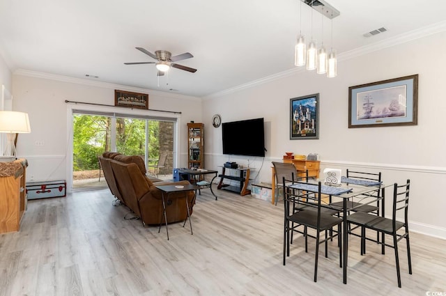 dining space with ornamental molding and light hardwood / wood-style floors