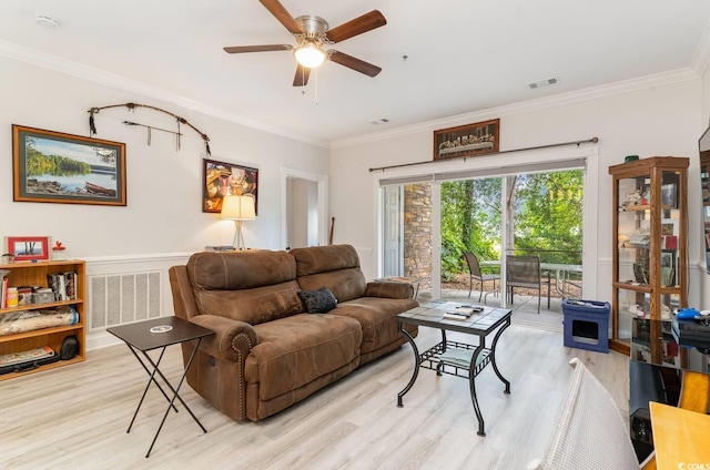 living room with ceiling fan, ornamental molding, and light hardwood / wood-style flooring