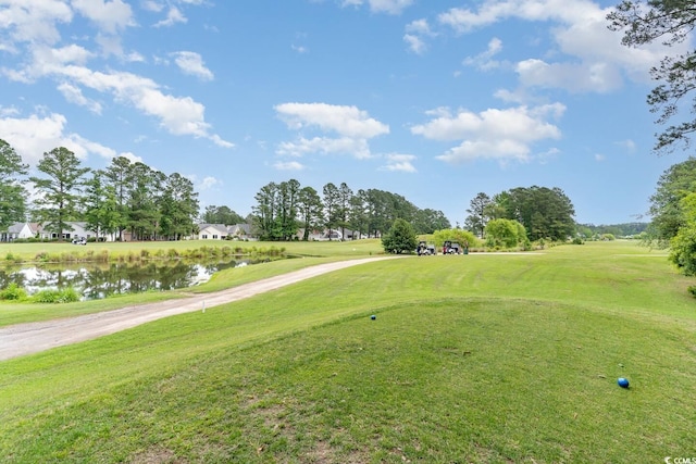 view of community with a water view and a yard