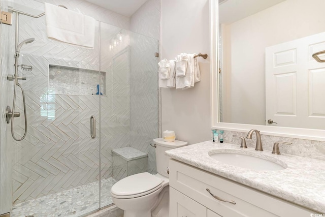 bathroom with vanity, toilet, and walk in shower