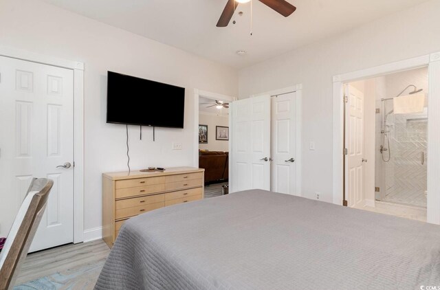 bedroom featuring connected bathroom, ceiling fan, and light wood-type flooring