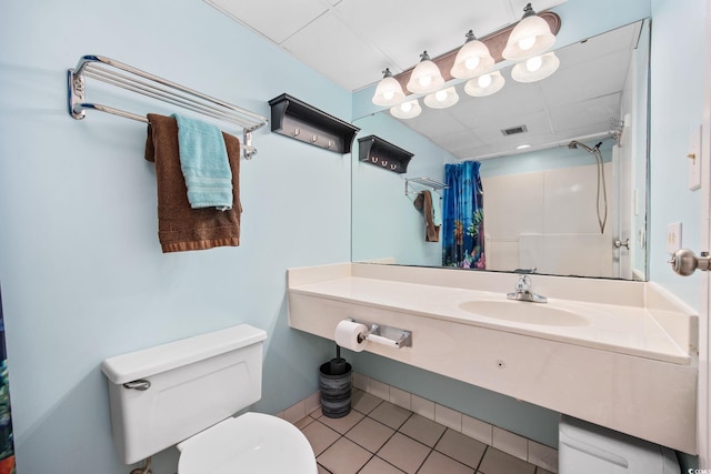 bathroom with tile patterned floors, a shower with curtain, vanity, and toilet