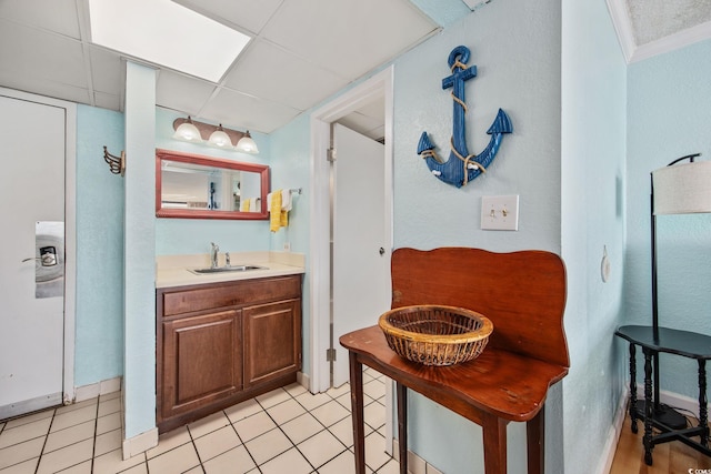 bathroom with tile patterned floors, vanity, and ornamental molding