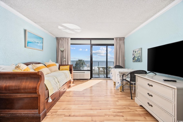 living room featuring crown molding, expansive windows, light hardwood / wood-style floors, and a textured ceiling