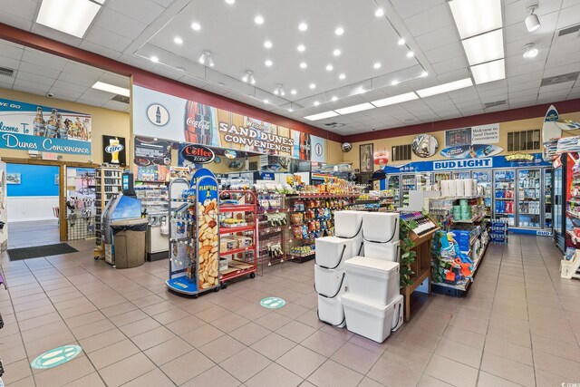 miscellaneous room with light tile patterned floors and a drop ceiling