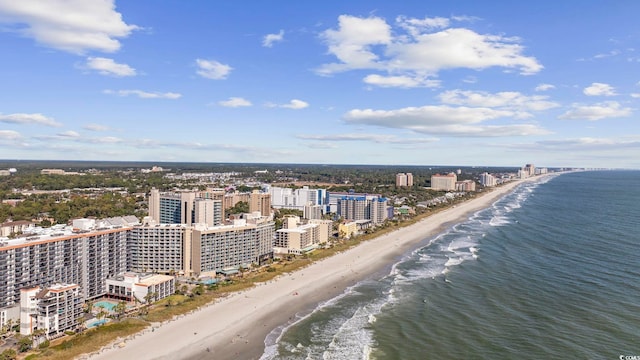 birds eye view of property with a water view and a view of the beach