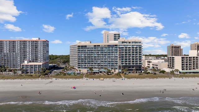 view of property with a water view and a view of the beach