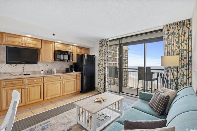 4800 S Ocean Blvd Unit 1219, North Myrtle Beach, SC 29582 - living room featuring light tile patterned flooring and a textured ceiling