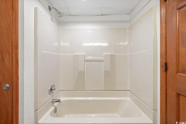 bathroom featuring bathing tub / shower combination and a paneled ceiling