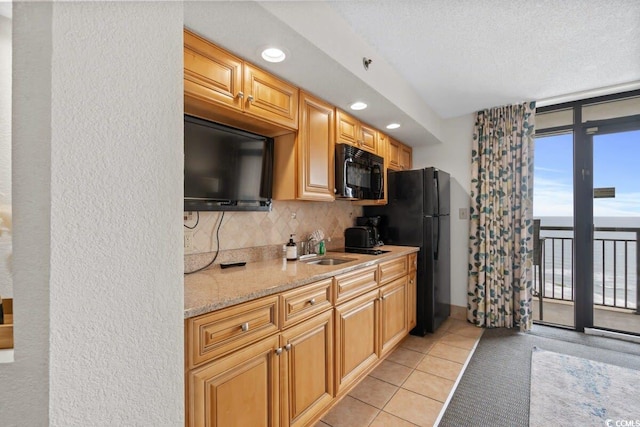 4800 S Ocean Blvd Unit 1219, North Myrtle Beach, SC 29582 - kitchen with black appliances, light tile patterned flooring, backsplash, light stone countertops, and recessed lighting