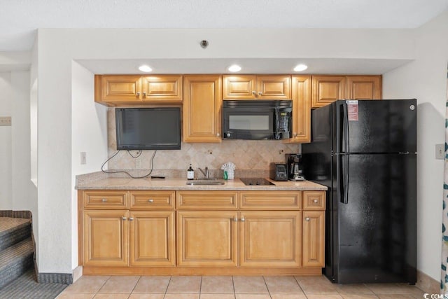 4800 S Ocean Blvd Unit 1219, North Myrtle Beach, SC 29582 - kitchen featuring light tile patterned floors, a sink, light stone countertops, decorative backsplash, and black appliances