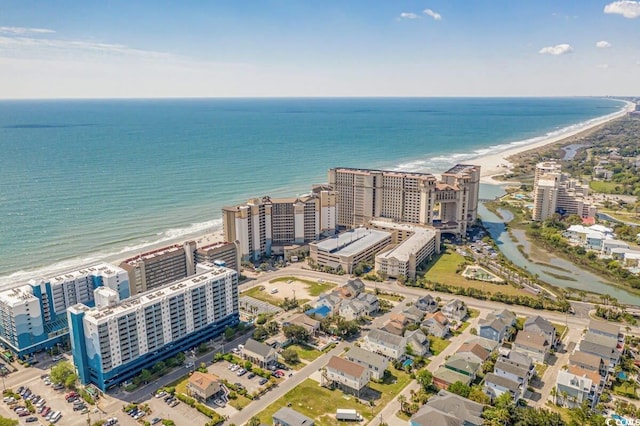 drone / aerial view featuring a beach view and a water view