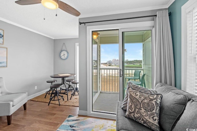 doorway to outside with a wealth of natural light, ceiling fan, ornamental molding, and hardwood / wood-style flooring