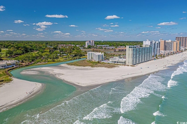 birds eye view of property featuring a beach view and a water view