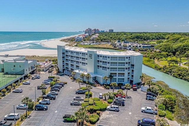 birds eye view of property with a beach view and a water view