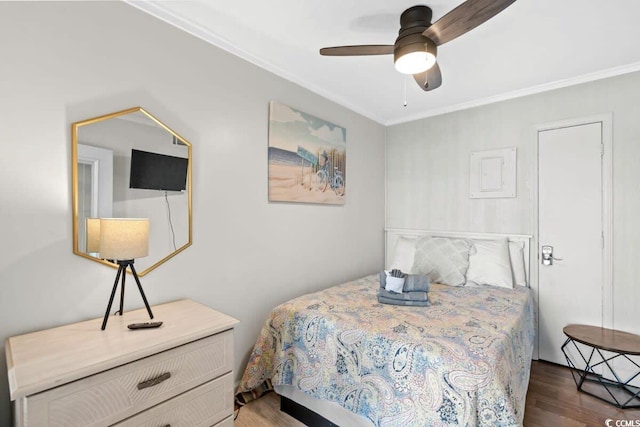 bedroom with crown molding, ceiling fan, and dark hardwood / wood-style floors