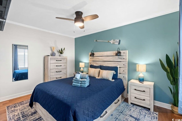 bedroom with hardwood / wood-style floors, ceiling fan, and ornamental molding