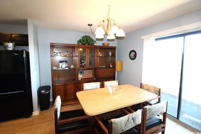 dining room featuring light hardwood / wood-style floors and a notable chandelier