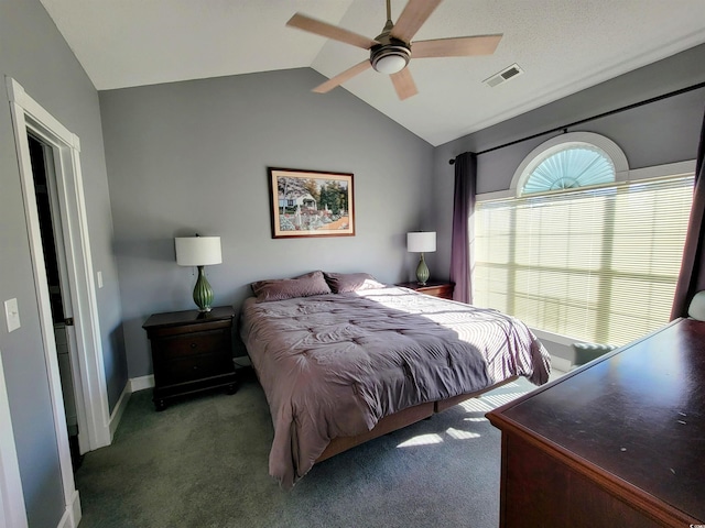 bedroom featuring ceiling fan, dark carpet, and lofted ceiling