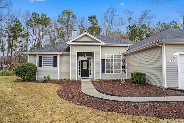 view of front of house featuring a garage and a front yard