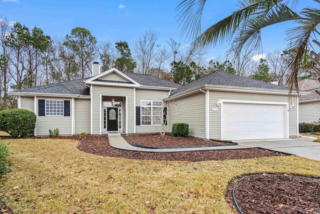 ranch-style house featuring a front yard and a garage