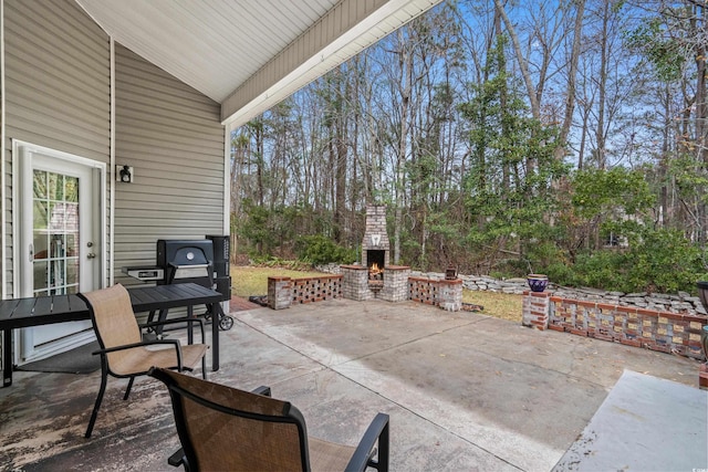 view of patio with an outdoor brick fireplace