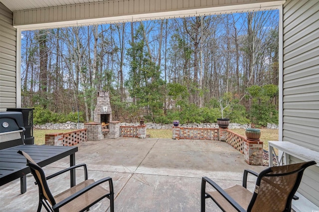 view of patio featuring an outdoor brick fireplace