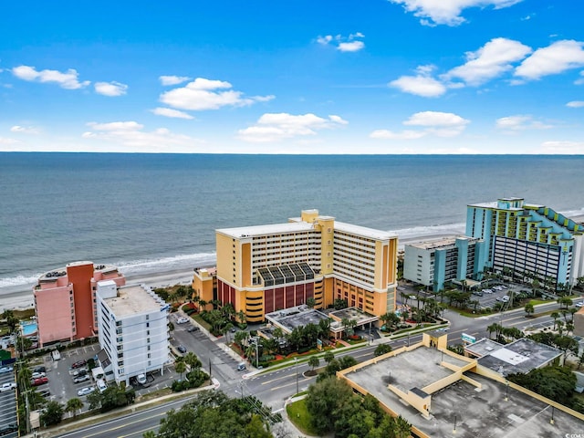 drone / aerial view featuring a water view and a view of the beach