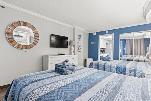 bedroom with wood-type flooring, a textured ceiling, ornamental molding, and radiator heating unit