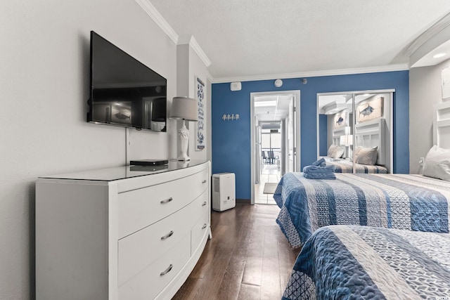 bedroom featuring dark hardwood / wood-style flooring, a textured ceiling, and ornamental molding