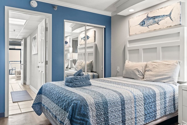 tiled bedroom with a closet and ornamental molding