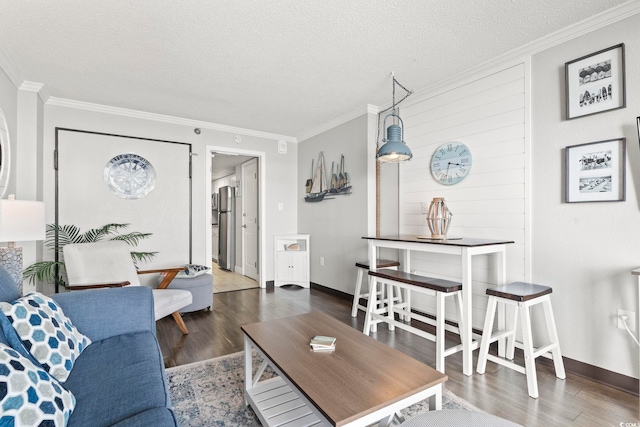 living room with ornamental molding, a textured ceiling, and dark wood-type flooring