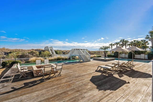 deck featuring a fenced in pool