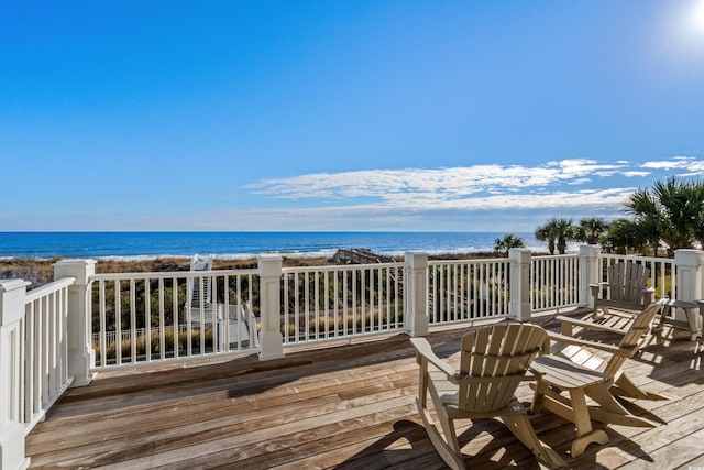 deck with a water view and a view of the beach