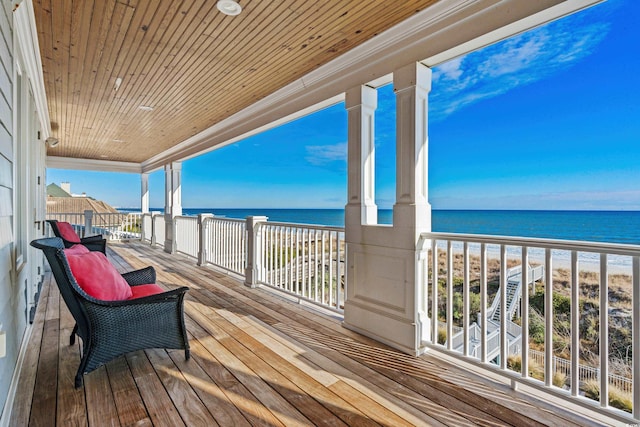 deck featuring a water view and a view of the beach