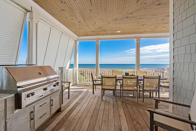 sunroom / solarium with lofted ceiling, a water view, wooden ceiling, and a beach view