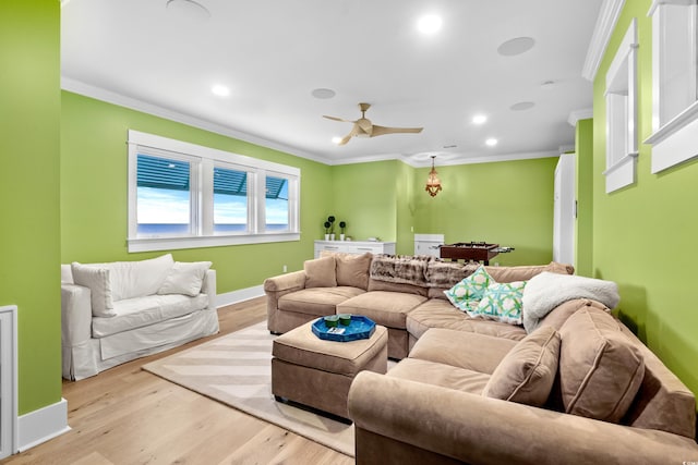 living room featuring ceiling fan, light hardwood / wood-style floors, and ornamental molding