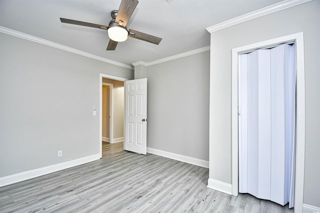 unfurnished bedroom with ceiling fan, crown molding, and light hardwood / wood-style flooring